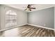 Bedroom featuring a large window, ceiling fan, and wood-look flooring at 3150 Soft Breezes Dr # 1050, Las Vegas, NV 89128