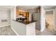 The kitchen features wood cabinets, a breakfast bar, and granite countertops at 3150 Soft Breezes Dr # 1050, Las Vegas, NV 89128