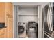 Convenient laundry closet features a washer, dryer, and built-in shelving for storage at 3150 Soft Breezes Dr # 1050, Las Vegas, NV 89128