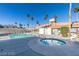 Community pool and hot tub area with lounge chairs and well-maintained landscaping at 3150 Soft Breezes Dr # 1050, Las Vegas, NV 89128