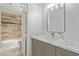 Remodeled bathroom with marble countertop, new vanity, new fixtures, and a view into the shower/tub at 326 Fuente Dr, Henderson, NV 89014