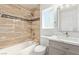 Nicely remodeled bathroom features gray vanity, marble countertop, new fixtures, and tiled shower at 326 Fuente Dr, Henderson, NV 89014