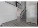 Light-filled entryway with gray laminate flooring and a staircase at 326 Fuente Dr, Henderson, NV 89014