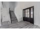 Bright entryway features sleek gray laminate flooring and staircase at 326 Fuente Dr, Henderson, NV 89014