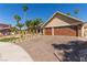 Single-story home with a three-car garage and beautiful desert landscaping at 326 Fuente Dr, Henderson, NV 89014