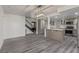 Open floor plan featuring living room and kitchen with stainless appliances, island seating, and an adjacent staircase at 326 Fuente Dr, Henderson, NV 89014