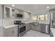 This kitchen is complete with stainless steel appliances and sleek gray cabinets at 326 Fuente Dr, Henderson, NV 89014