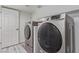 Well-lit laundry room features a side-by-side washer and dryer at 326 Fuente Dr, Henderson, NV 89014
