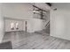 Expansive open living area with staircase, fireplace, and modern flooring at 326 Fuente Dr, Henderson, NV 89014