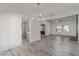 Bright, open-concept living area with wood floors, modern lighting, and seamless flow to kitchen at 326 Fuente Dr, Henderson, NV 89014