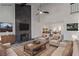 Staged living room featuring a fireplace, modern furnishings, and sleek flooring at 326 Fuente Dr, Henderson, NV 89014