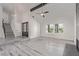 Bright living room featuring wood floors, beamed ceiling, and ample natural light from large windows at 326 Fuente Dr, Henderson, NV 89014