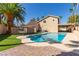 Backyard pool featuring brick patio, palm trees, and a covered patio for entertaining at 326 Fuente Dr, Henderson, NV 89014