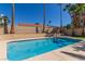 Backyard swimming pool surrounded by palm trees, and decorative landscaping at 326 Fuente Dr, Henderson, NV 89014