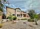 Home backyard with small trees, bushes, rocks, and artificial grass at 3624 Pelican Brief Ln, North Las Vegas, NV 89084