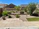 Backyard features desert landscaping, a small area of green grass and fencing at 3624 Pelican Brief Ln, North Las Vegas, NV 89084