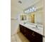 Bathroom featuring a double vanity with dark wood cabinets and a large mirror at 3624 Pelican Brief Ln, North Las Vegas, NV 89084
