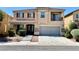 Two-story home featuring desert landscaping, a two car garage, and a small balcony at 3624 Pelican Brief Ln, North Las Vegas, NV 89084