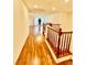 Upstairs hallway featuring hardwood floors with railings overlooking living space at 3624 Pelican Brief Ln, North Las Vegas, NV 89084