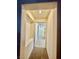 Inviting hallway featuring built-in shelving and tiled flooring with natural light at 3624 Pelican Brief Ln, North Las Vegas, NV 89084