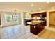 Spacious kitchen featuring a granite island, modern appliances, and an adjacent dining area at 3624 Pelican Brief Ln, North Las Vegas, NV 89084