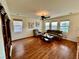 Inviting living room featuring hardwood floors, comfortable seating, and natural light at 3624 Pelican Brief Ln, North Las Vegas, NV 89084