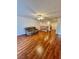 Spacious living area boasting hardwood floors, ceiling fan, and staircase with wooden banister at 3624 Pelican Brief Ln, North Las Vegas, NV 89084