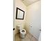 Toilet room with ceramic tile and square mirror at 3624 Pelican Brief Ln, North Las Vegas, NV 89084