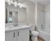 Modern bathroom with a white vanity, large mirror, and a shower-tub combination with white tile surround at 3713 Nairobi Ln, North Las Vegas, NV 89032
