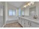 Well-lit bathroom with double vanity, separate shower, and a luxurious soaking tub for relaxation at 3713 Nairobi Ln, North Las Vegas, NV 89032