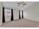 Bright bedroom with neutral carpet, ceiling fan, and dual windows offering lots of natural light at 3713 Nairobi Ln, North Las Vegas, NV 89032