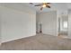 Spacious bedroom with neutral walls, a ceiling fan, and an ensuite bathroom featuring a soaking tub at 3713 Nairobi Ln, North Las Vegas, NV 89032