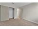 Comfortable bedroom with neutral carpet, a closet with sliding doors, and a doorway leading to another room at 3713 Nairobi Ln, North Las Vegas, NV 89032