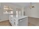 Kitchen island featuring white cabinets, drawers, and a quartz countertop at 3713 Nairobi Ln, North Las Vegas, NV 89032