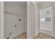 Practical laundry area with tile floors, shelving, and washer-dryer hookups for added convenience at 3713 Nairobi Ln, North Las Vegas, NV 89032