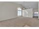 Bright living room with neutral walls and carpet and a modern light fixture at 3713 Nairobi Ln, North Las Vegas, NV 89032