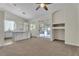Bright living space with carpet, open to kitchen with island and sliding glass door at 3713 Nairobi Ln, North Las Vegas, NV 89032