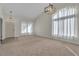 Bright room with large windows, neutral carpet, and modern lighting fixtures at 3713 Nairobi Ln, North Las Vegas, NV 89032