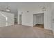 Bright living room with modern lighting, carpet, and convenient access to other rooms at 3713 Nairobi Ln, North Las Vegas, NV 89032