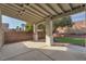 View of a covered patio with ample space for entertaining, overlooking the backyard and landscaped area at 3713 Nairobi Ln, North Las Vegas, NV 89032