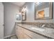Bathroom featuring double sinks with granite countertops and modern lighting at 4078 Gold Coast Dr, Las Vegas, NV 89121