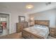Serene bedroom with wooden dresser, mirror, and view of another room at 4078 Gold Coast Dr, Las Vegas, NV 89121