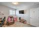 Cozy bedroom area with TV, storage, and comfortable seating, perfect for relaxation at 4078 Gold Coast Dr, Las Vegas, NV 89121