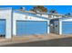 Exterior view of garages with blue doors, offering ample parking and storage space at 4078 Gold Coast Dr, Las Vegas, NV 89121