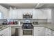 A bright kitchen featuring stainless steel appliances and granite countertops at 4078 Gold Coast Dr, Las Vegas, NV 89121