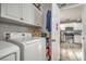 A well-organized laundry area with modern appliances and ample storage cabinets at 4078 Gold Coast Dr, Las Vegas, NV 89121