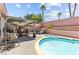 Serene backyard with pool, spa, covered patio, and egg chair at 4115 Ridgewood Ave, Las Vegas, NV 89120