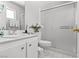 Clean bathroom with white cabinets, sink, toilet, and shower with sliding glass door at 4115 Ridgewood Ave, Las Vegas, NV 89120