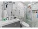 Modern bathroom featuring stylish sink, elegant marble walls, glass enclosed shower, and a luxury toilet at 4115 Ridgewood Ave, Las Vegas, NV 89120