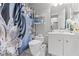 Bright bathroom with white vanity, decorative shower curtain, and toilet at 4115 Ridgewood Ave, Las Vegas, NV 89120